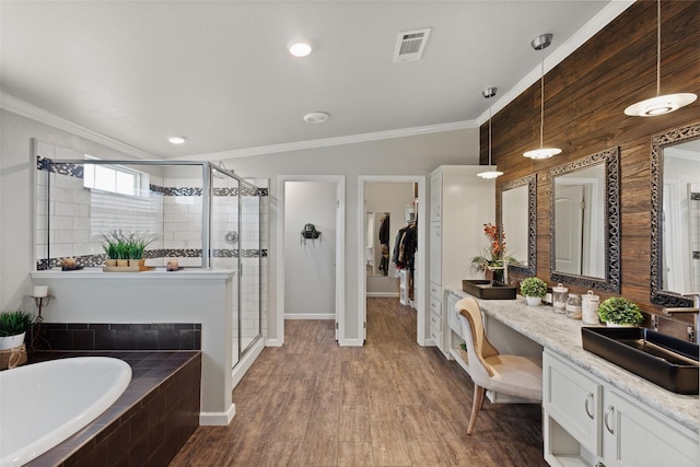 bathroom with a shower stall, crown molding, visible vents, a garden tub, and vanity