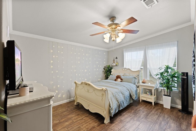 bedroom featuring crown molding, a ceiling fan, visible vents, baseboards, and wood finished floors