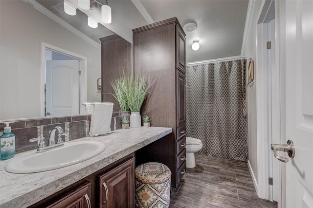 bathroom featuring wood finished floors, ornamental molding, toilet, vanity, and curtained shower