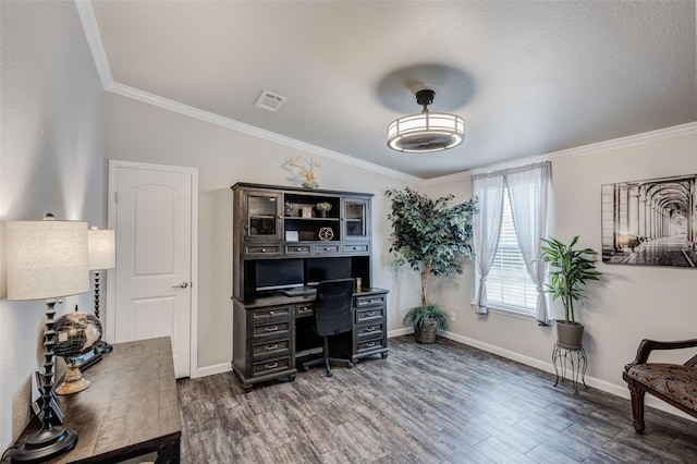 home office featuring dark wood-type flooring, visible vents, and ornamental molding