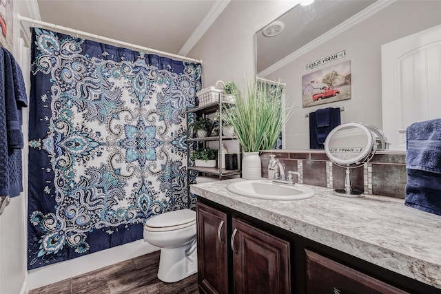 full bathroom featuring wood finished floors, ornamental molding, backsplash, toilet, and vanity