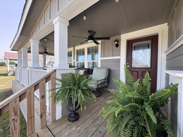 wooden terrace featuring ceiling fan and a porch