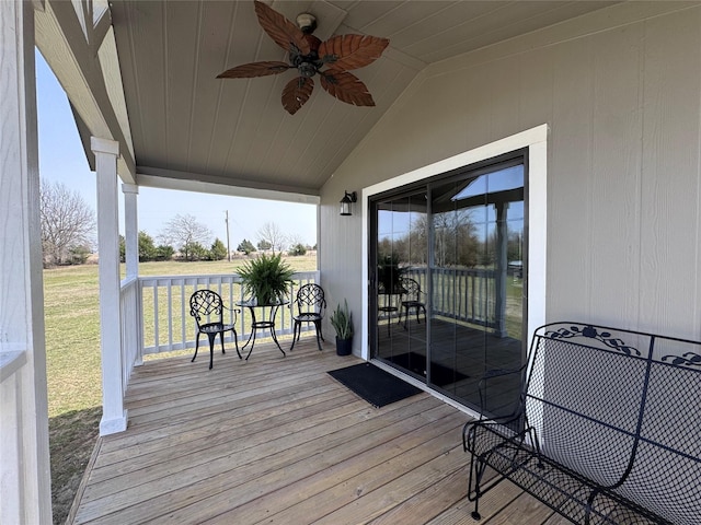 wooden deck featuring covered porch and ceiling fan