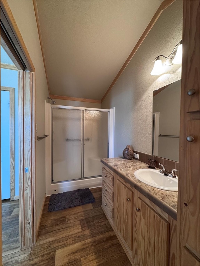 4081 Fm 2736, Campbell, TX 75422 - full bath with lofted ceiling, a shower stall, ornamental molding, vanity, and wood finished floors