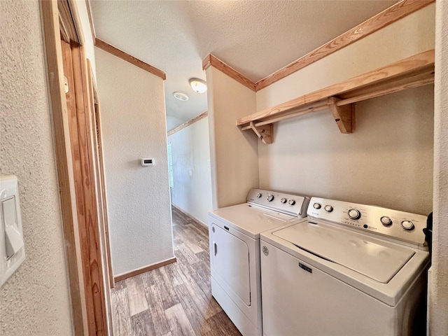 4081 Fm 2736, Campbell, TX 75422 - clothes washing area featuring separate washer and dryer, light wood-style floors, a textured ceiling, a textured wall, and ornamental molding
