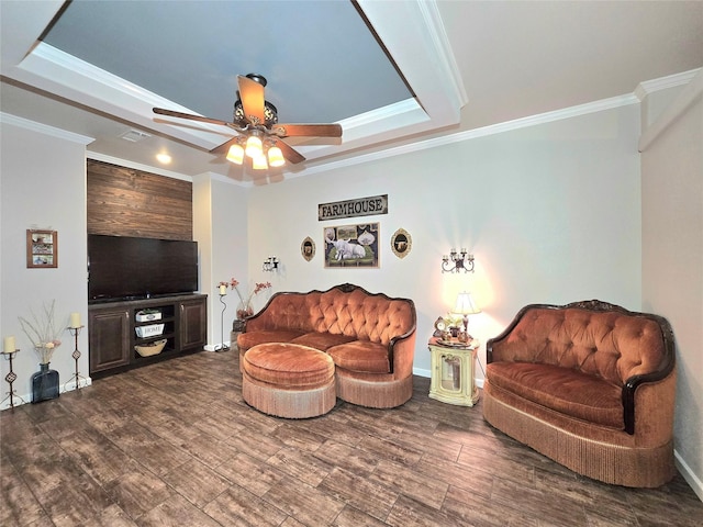 living area with crown molding, a ceiling fan, and a raised ceiling