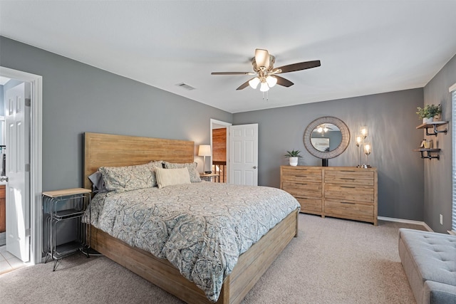 carpeted bedroom with a ceiling fan, visible vents, and baseboards