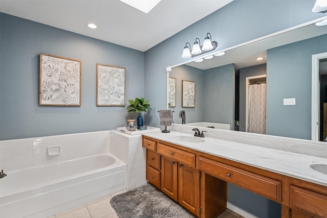 full bathroom with tile patterned flooring, a garden tub, double vanity, and a sink