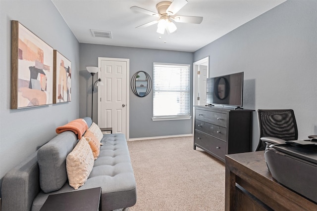 office space with light carpet, baseboards, visible vents, and ceiling fan