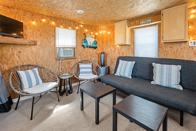 carpeted living room featuring cooling unit and baseboards