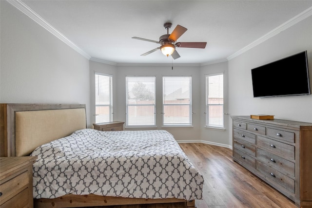 bedroom with light wood-style flooring, multiple windows, and ornamental molding