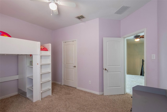 unfurnished bedroom featuring a ceiling fan, carpet, visible vents, and baseboards