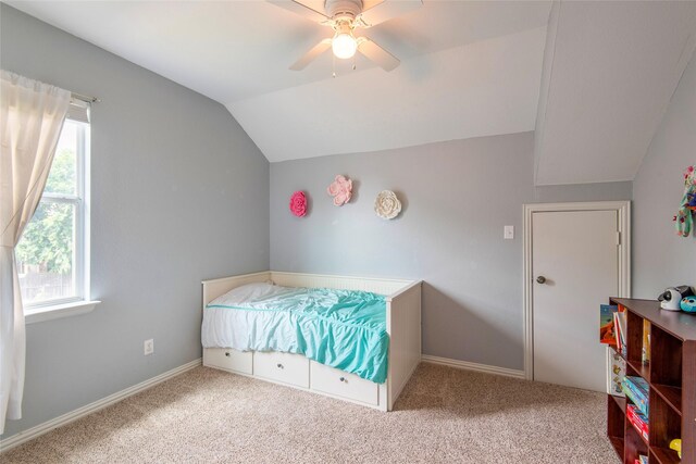 carpeted bedroom featuring lofted ceiling, ceiling fan, and baseboards