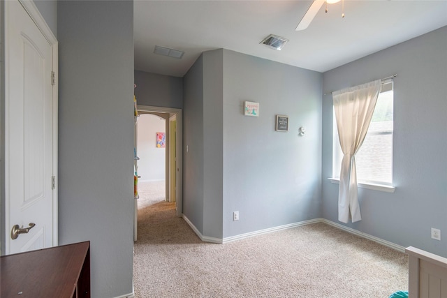 unfurnished bedroom with carpet floors, visible vents, ceiling fan, and baseboards