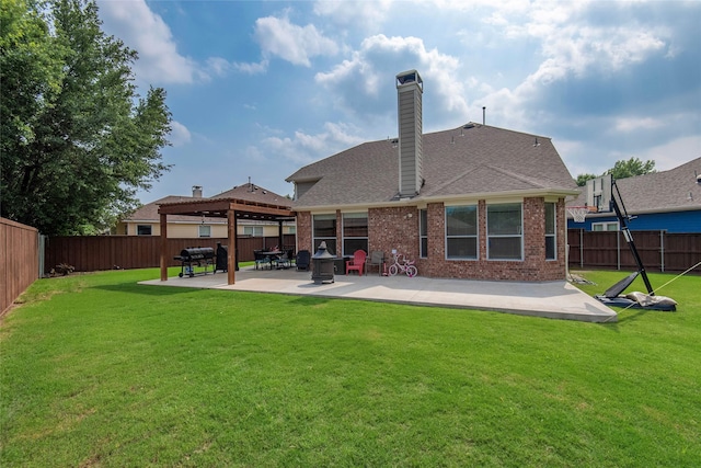 rear view of property featuring brick siding, a patio, a fenced backyard, and a lawn