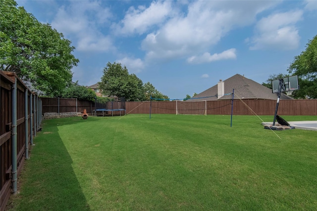 view of yard with a fenced backyard and a trampoline