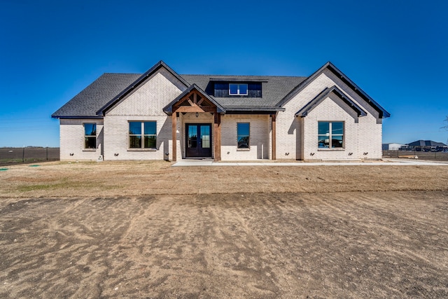 view of front of home featuring french doors and brick siding