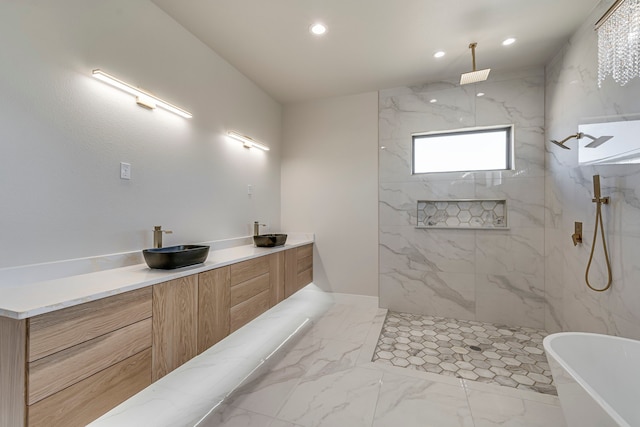 full bath featuring a marble finish shower, marble finish floor, a freestanding bath, a sink, and recessed lighting