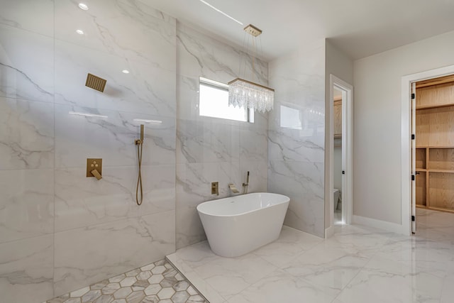 full bathroom with a freestanding tub, a marble finish shower, and marble finish floor