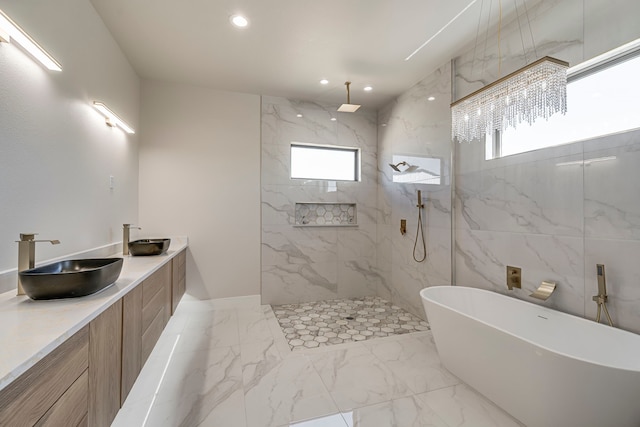 full bath featuring a healthy amount of sunlight, marble finish floor, a marble finish shower, and a sink