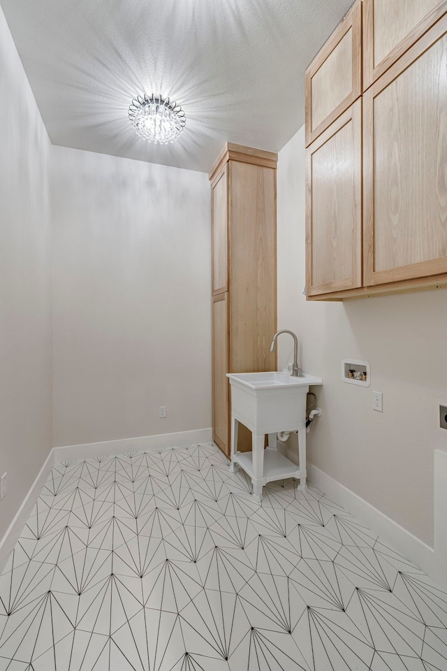 laundry area featuring washer hookup, cabinet space, electric dryer hookup, and baseboards