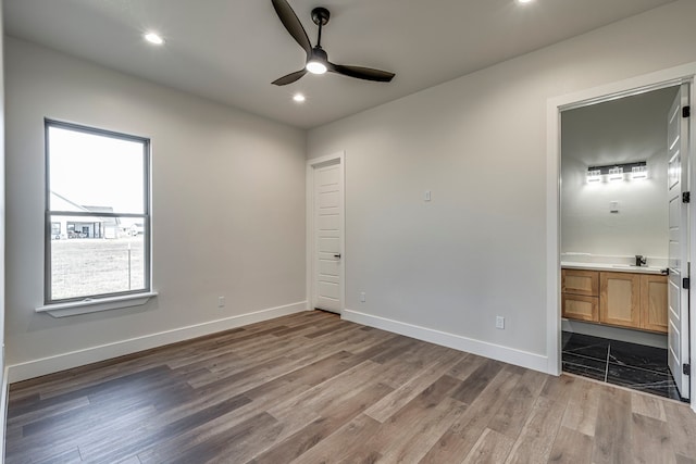 unfurnished bedroom with recessed lighting, light wood-style floors, connected bathroom, ceiling fan, and baseboards