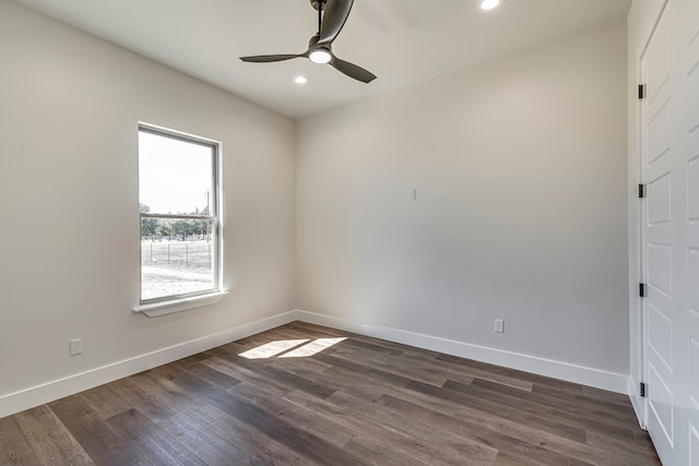 spare room with a ceiling fan, baseboards, dark wood-type flooring, and recessed lighting