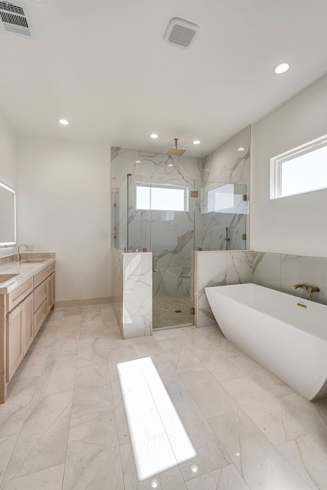 full bath featuring marble finish floor, a marble finish shower, visible vents, a freestanding bath, and vanity