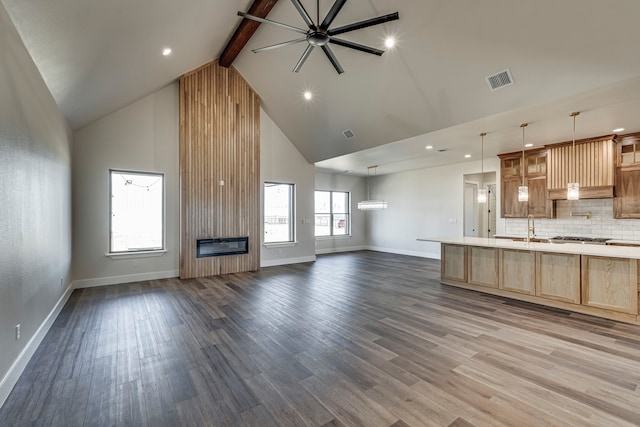 kitchen with open floor plan, light countertops, and dark wood finished floors