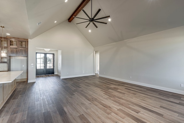 unfurnished living room featuring high vaulted ceiling, wood finished floors, visible vents, french doors, and beamed ceiling