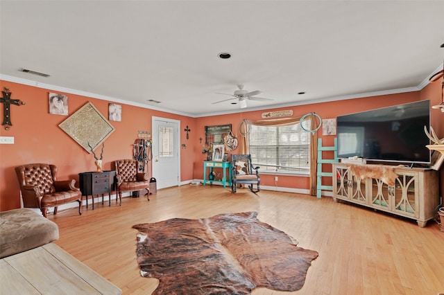 living room featuring ornamental molding and wood finished floors