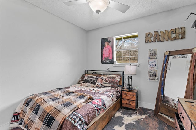 bedroom featuring concrete floors, ceiling fan, a textured ceiling, and baseboards