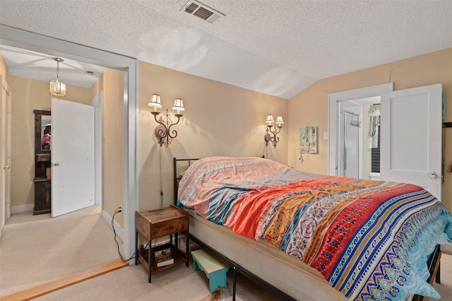 bedroom with light carpet, baseboards, visible vents, lofted ceiling, and a textured ceiling