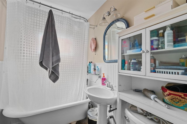 full bath featuring toilet, a shower with shower curtain, and a bath