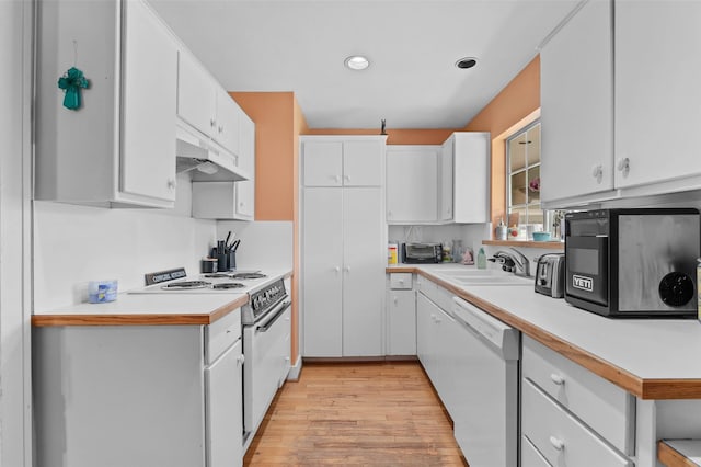 kitchen featuring light countertops, white cabinets, a sink, white appliances, and under cabinet range hood