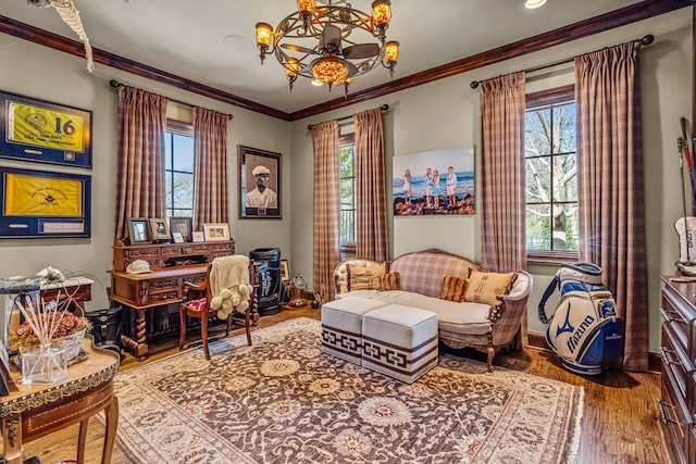 interior space featuring plenty of natural light, a chandelier, crown molding, and wood finished floors