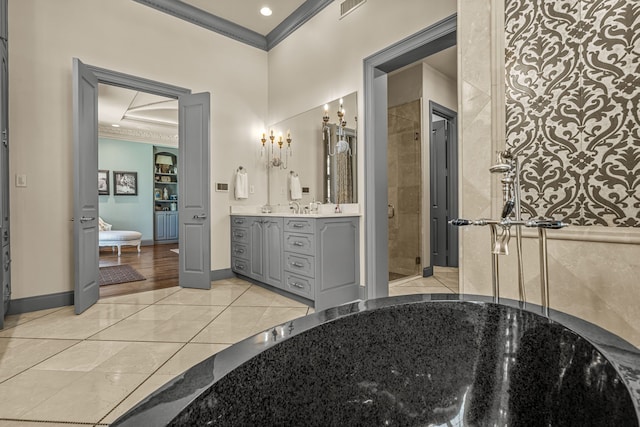 bathroom with a shower stall, baseboards, crown molding, and vanity