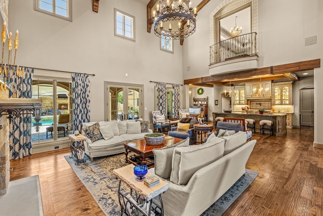 living room with a notable chandelier and wood finished floors