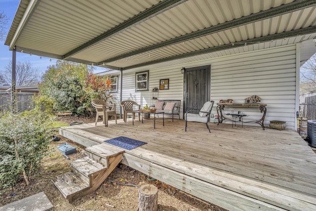 wooden terrace featuring fence