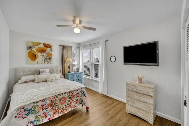 bedroom featuring ceiling fan, baseboards, and wood finished floors