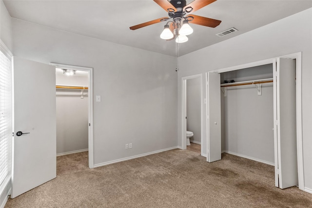 unfurnished bedroom featuring a ceiling fan, carpet, a closet, and visible vents