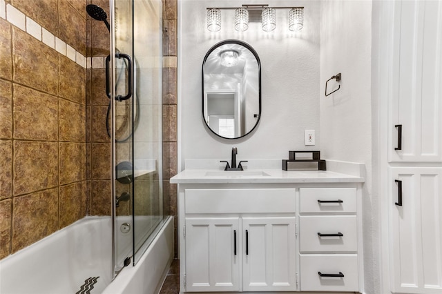 bathroom with vanity and bath / shower combo with glass door