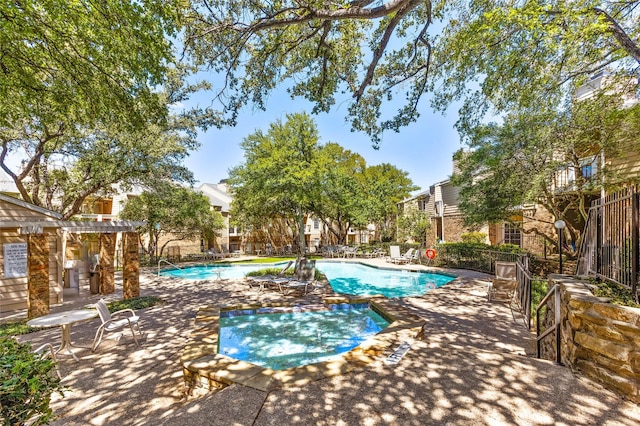 community pool with a patio area and a pergola