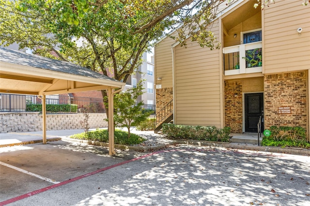 exterior space featuring brick siding and fence