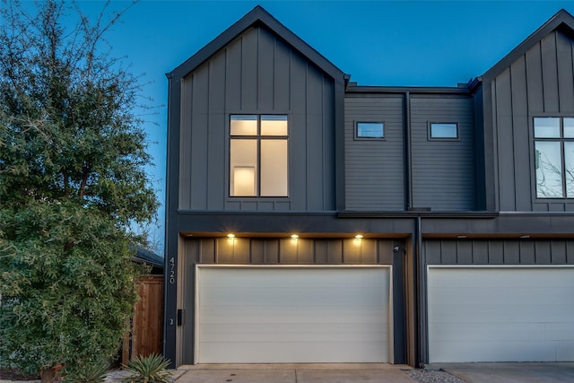 view of front facade featuring board and batten siding, concrete driveway, and a garage