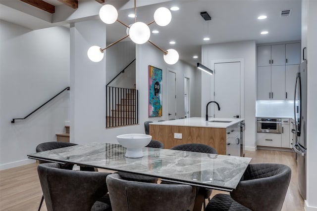 dining space with recessed lighting, visible vents, light wood-style flooring, and stairs