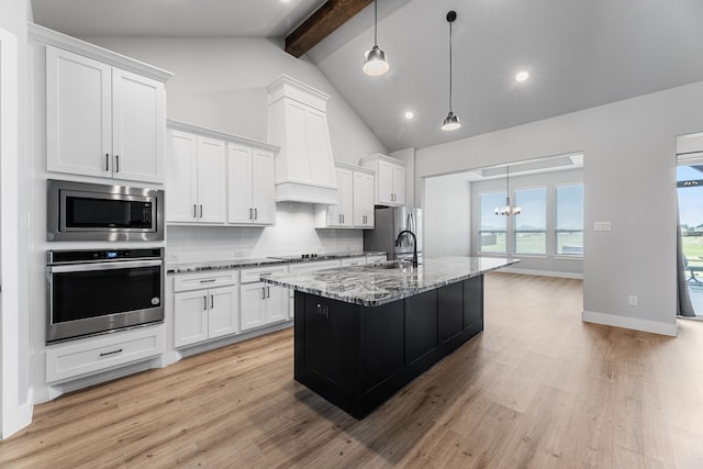 kitchen with stainless steel appliances, light wood finished floors, light stone countertops, tasteful backsplash, and beamed ceiling