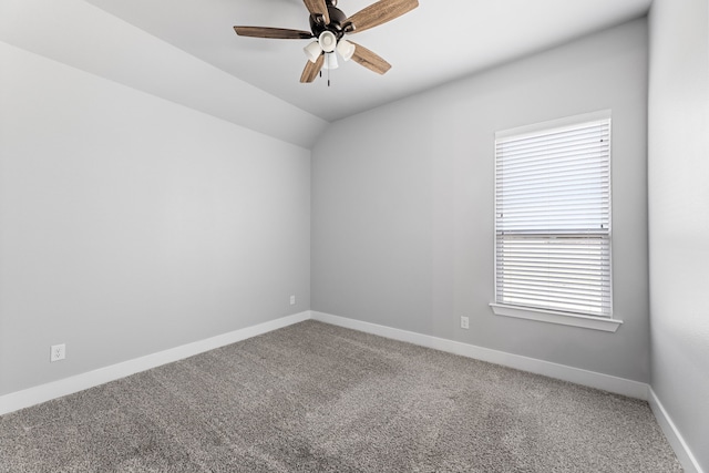 empty room featuring carpet, ceiling fan, lofted ceiling, and baseboards