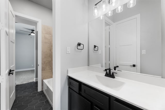 full bath featuring a ceiling fan, vanity, and tile patterned floors