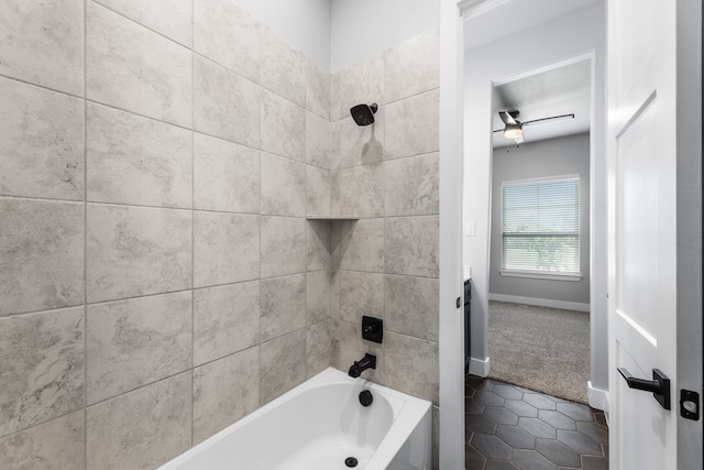 full bathroom with washtub / shower combination, tile patterned flooring, baseboards, and a ceiling fan